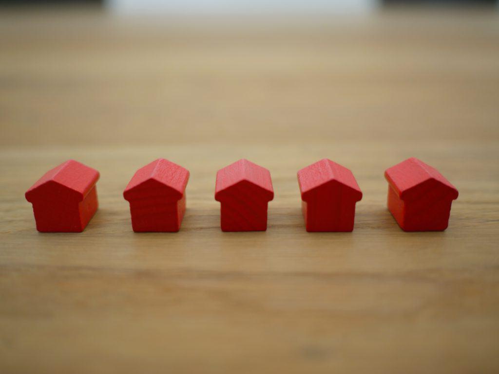 little red houses sitting on a table expert management